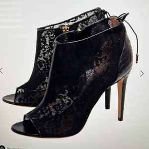 Salvatore Ferragamo black lace, and python trim peep toe ankle boots.